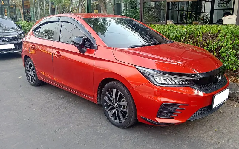 Orange Honda City Hatchback RS, front three-quarter view